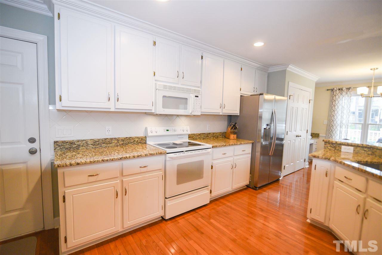 9200 Dawnshire Road Raleigh, NC 27615 - Photo 8 of 30 a kitchen with granite countertop white cabinets and white appliances