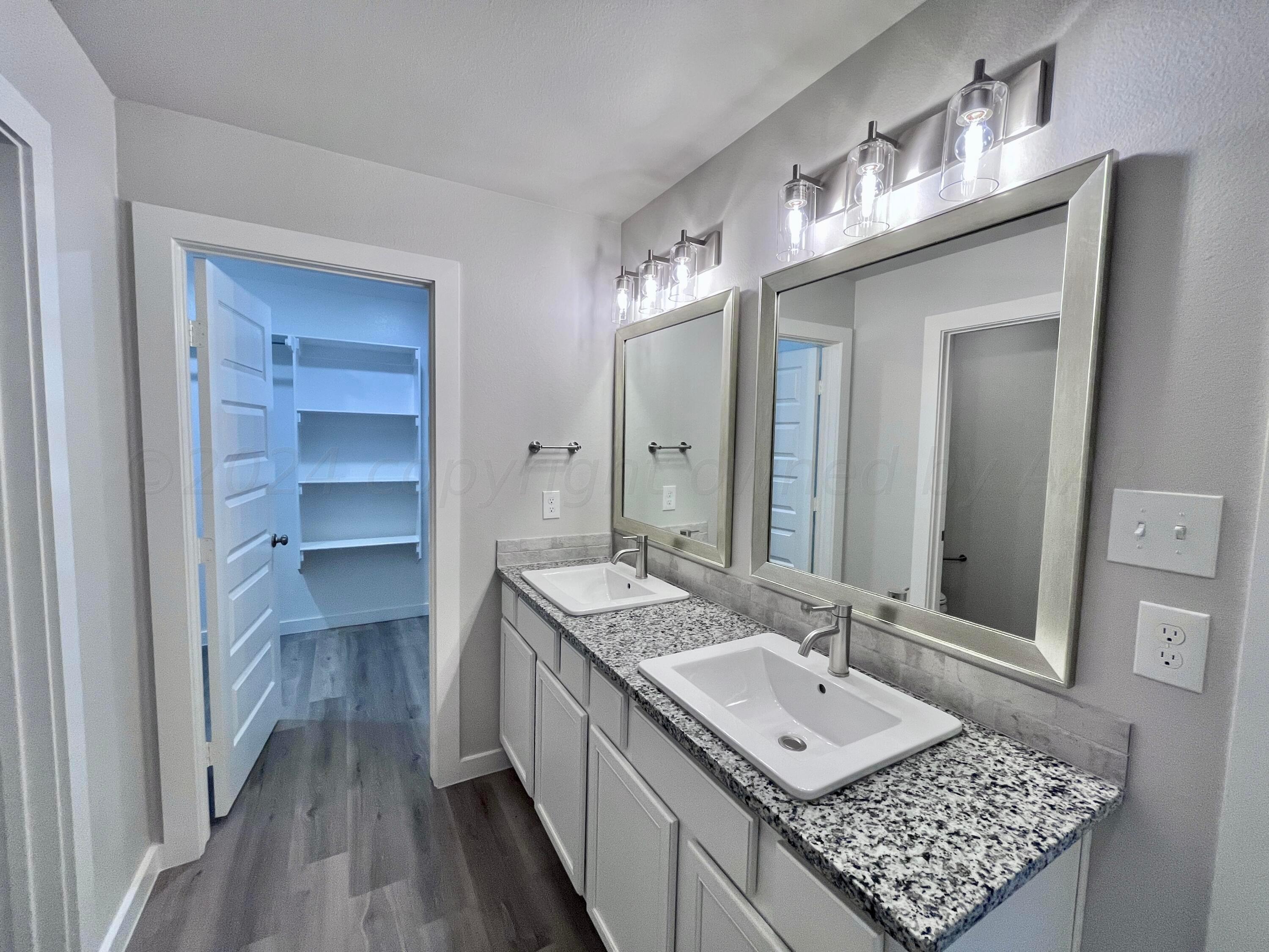 3103 Swenson Street Amarillo, TX 79124 - Photo 11 of 23 a bathroom with a sink a vanity and a mirror