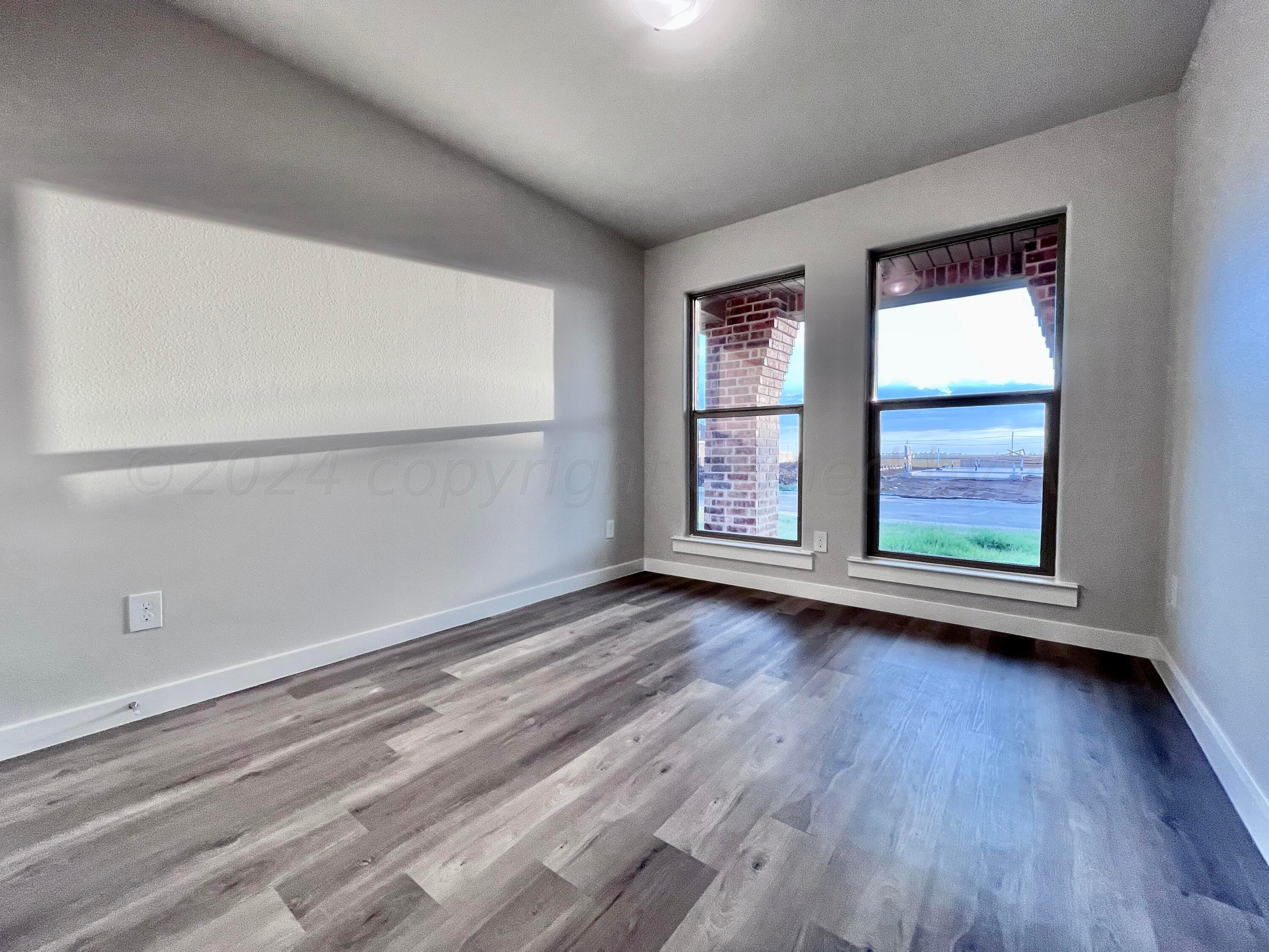 3103 Swenson Street Amarillo, TX 79124 - Photo 14 of 23 wooden floor in an empty room with a window