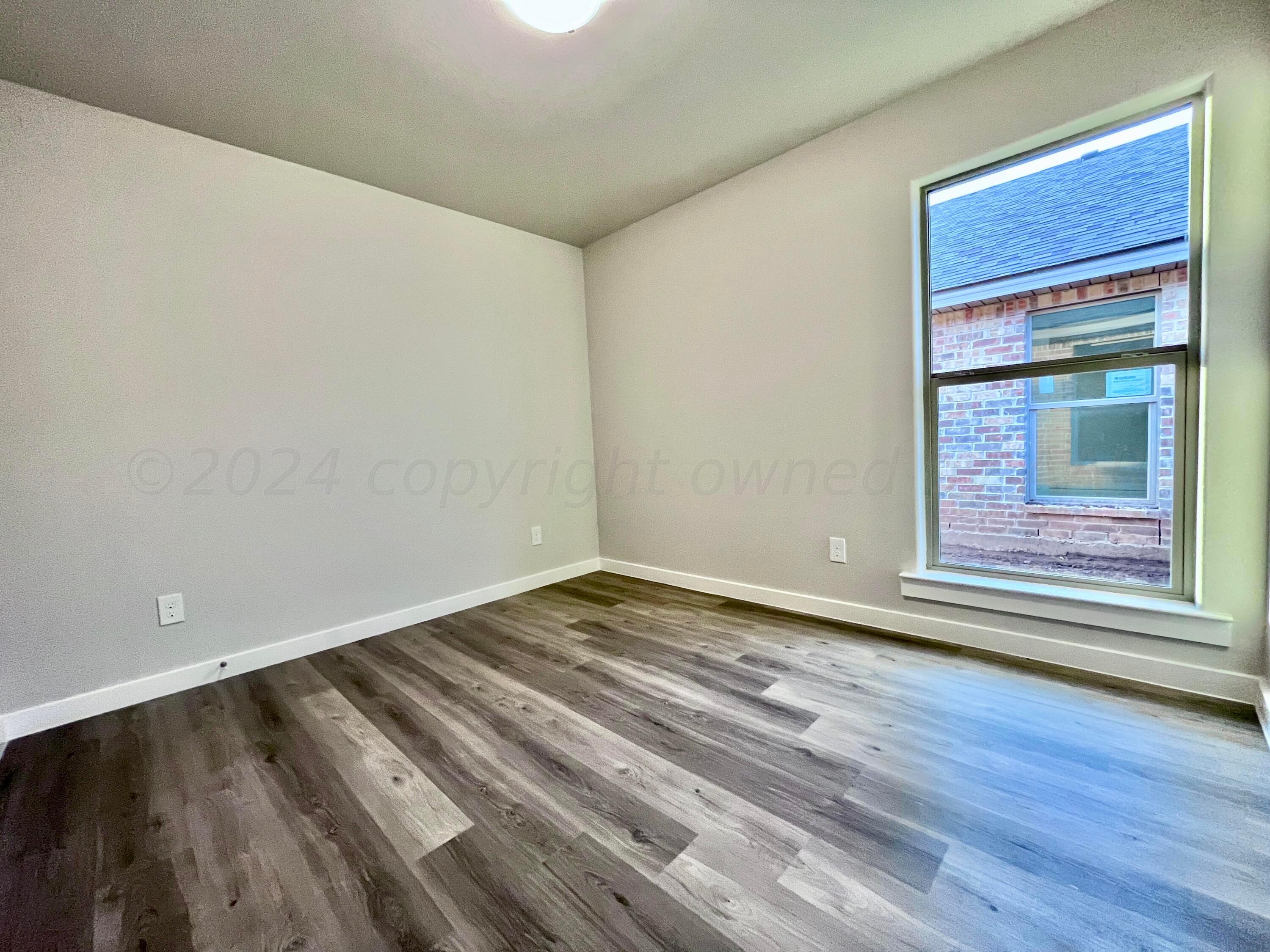 3103 Swenson Street Amarillo, TX 79124 - Photo 15 of 23 a view of an empty room and wooden floor