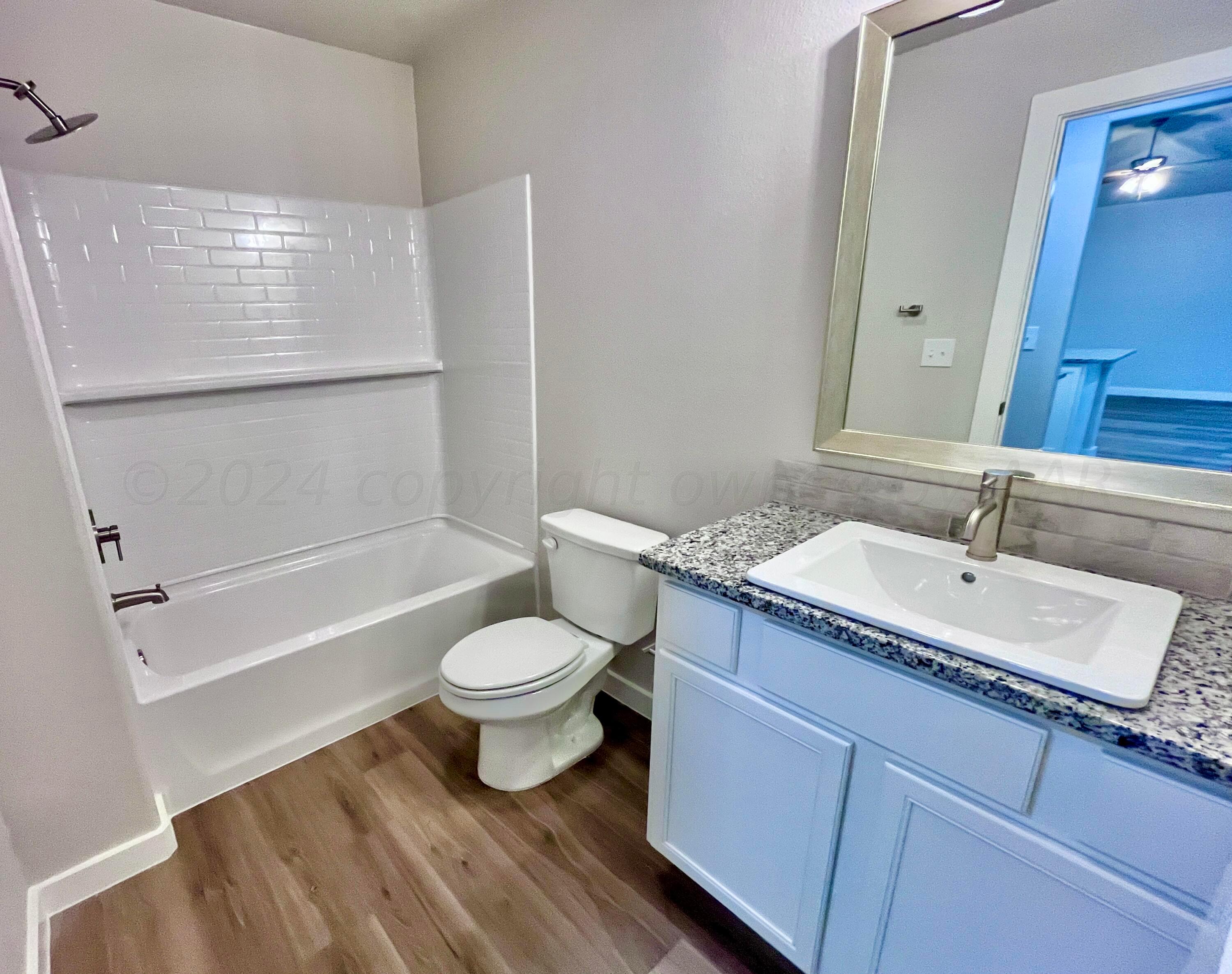 3103 Swenson Street Amarillo, TX 79124 - Photo 17 of 23 a bathroom with a granite countertop sink toilet and shower