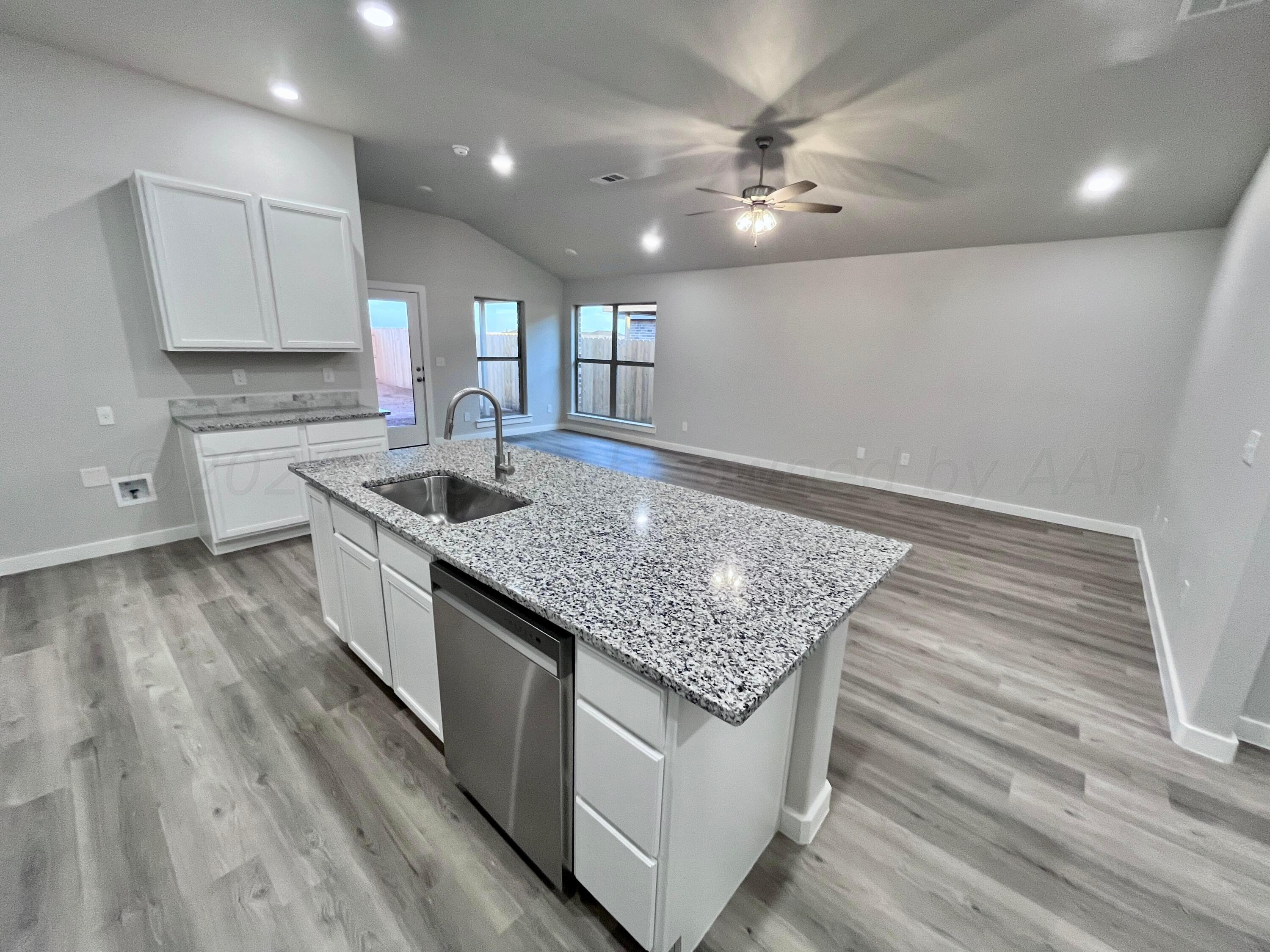3103 Swenson Street Amarillo, TX 79124 - Photo 6 of 23 a kitchen with stainless steel appliances granite countertop a sink stove and cabinets