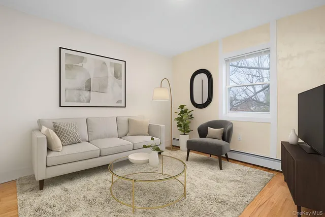a living room with furniture a flat screen tv and a large window