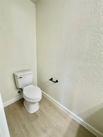 a white toilet sitting next to a white sink