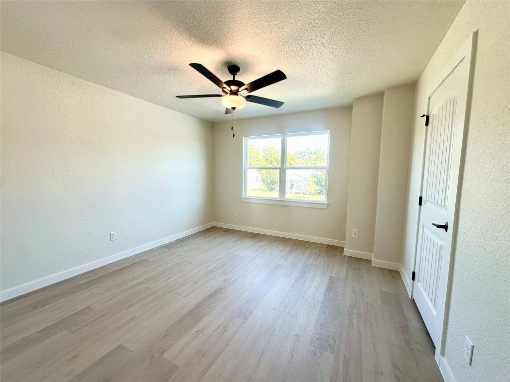1118 South 51st Street, Unit B Temple, TX 76504 - Photo 20 of 25 an empty room with wooden floor fan and windows