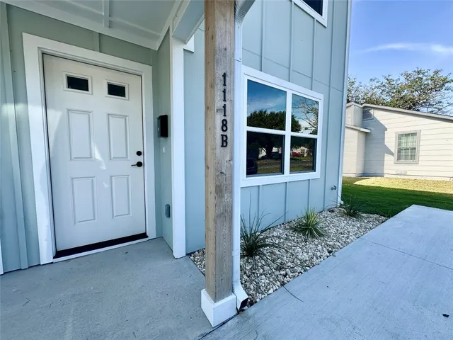 a view of front door and yard