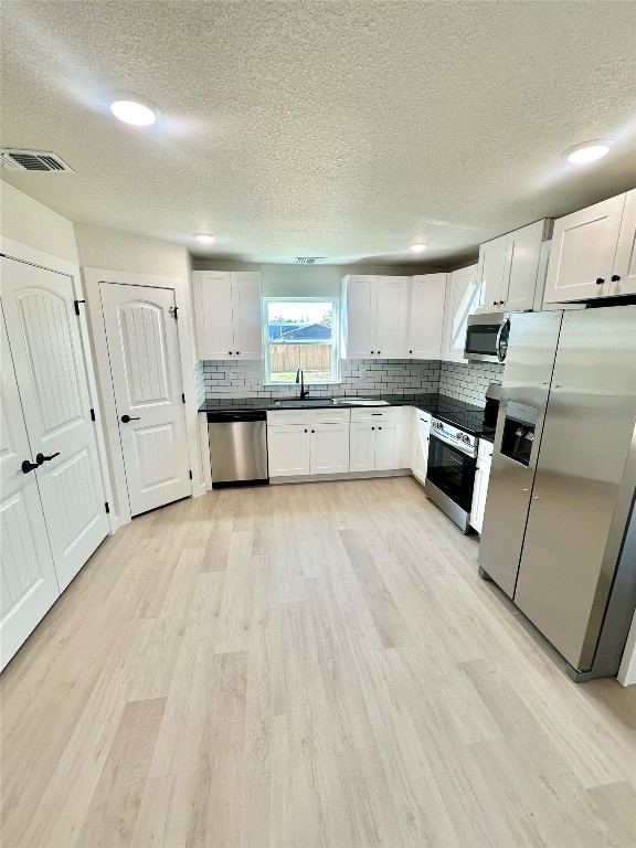 1118 South 51st Street, Unit B Temple, TX 76504 - Photo 10 of 25 a large kitchen with a lot of counter space and wooden floor