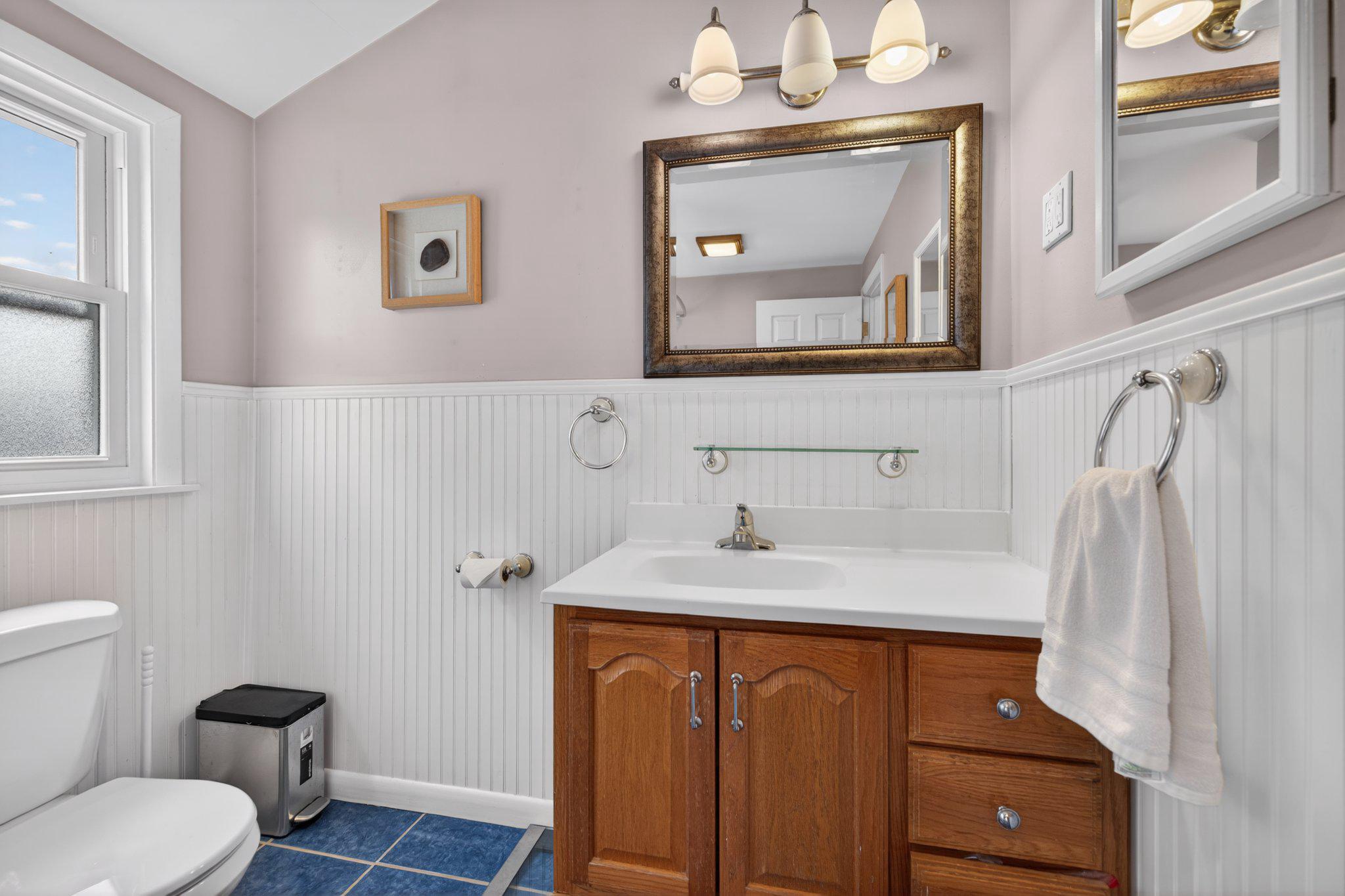 1002 Wilson Place Frederick, MD 21702 - Photo 19 of 30 a bathroom with a granite countertop sink toilet and mirror