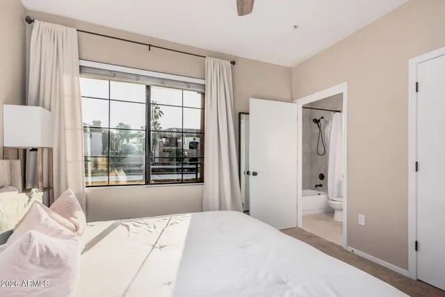 a bedroom with a bed and a view of bathroom