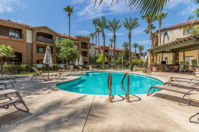 a swimming pool with outdoor seating and yard