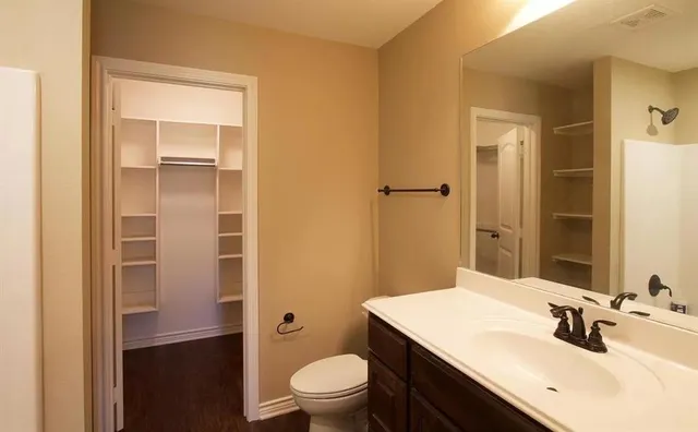 a bathroom with a sink a toilet a shower and a mirror