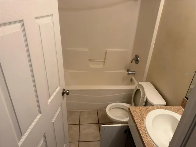 a bathroom with a sink and bathtub with toilet