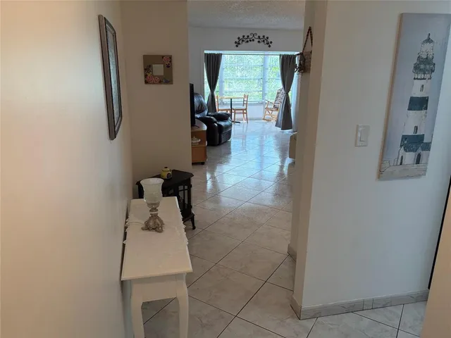 a hallway with furniture and a large window