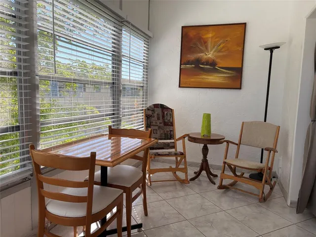 a dining room with furniture and window