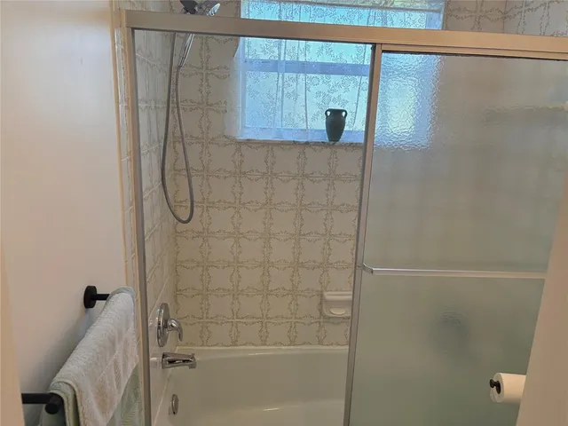 a bathroom with a bathtub and shower
