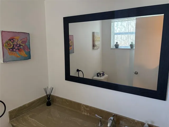 a view of a window and chair in the balcony