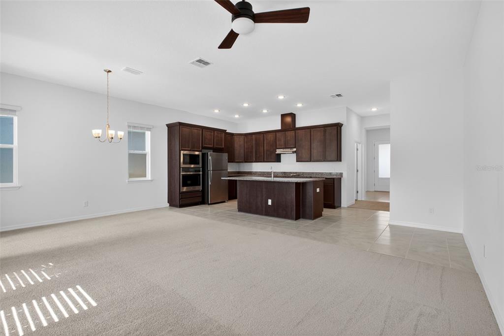 810 MIDDLETON Street DeBary, FL 32713 - Photo 14 of 52 a large kitchen with stainless steel appliances kitchen island a large counter top a sink stainless steel appliances and cabinets