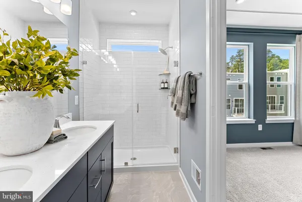 a bathroom with a granite countertop sink a toilet and shower