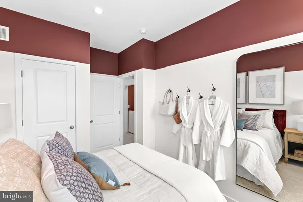 a bedroom with a bed and a white cabinet
