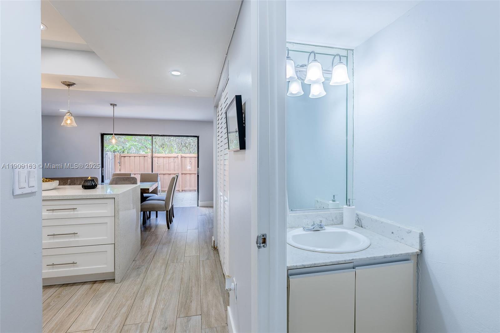 10037 Southwest 77th Court Miami, FL 33156 - Photo 11 of 70 a bathroom with a sink a toilet a mirror and shower