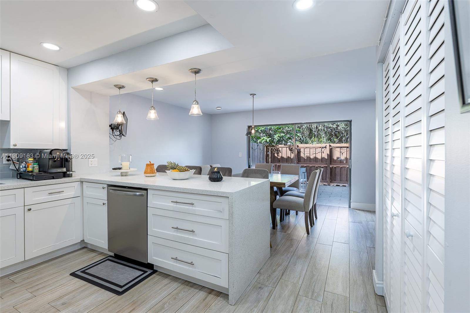 10037 Southwest 77th Court Miami, FL 33156 - Photo 12 of 70 a kitchen with a table chairs and wooden floor
