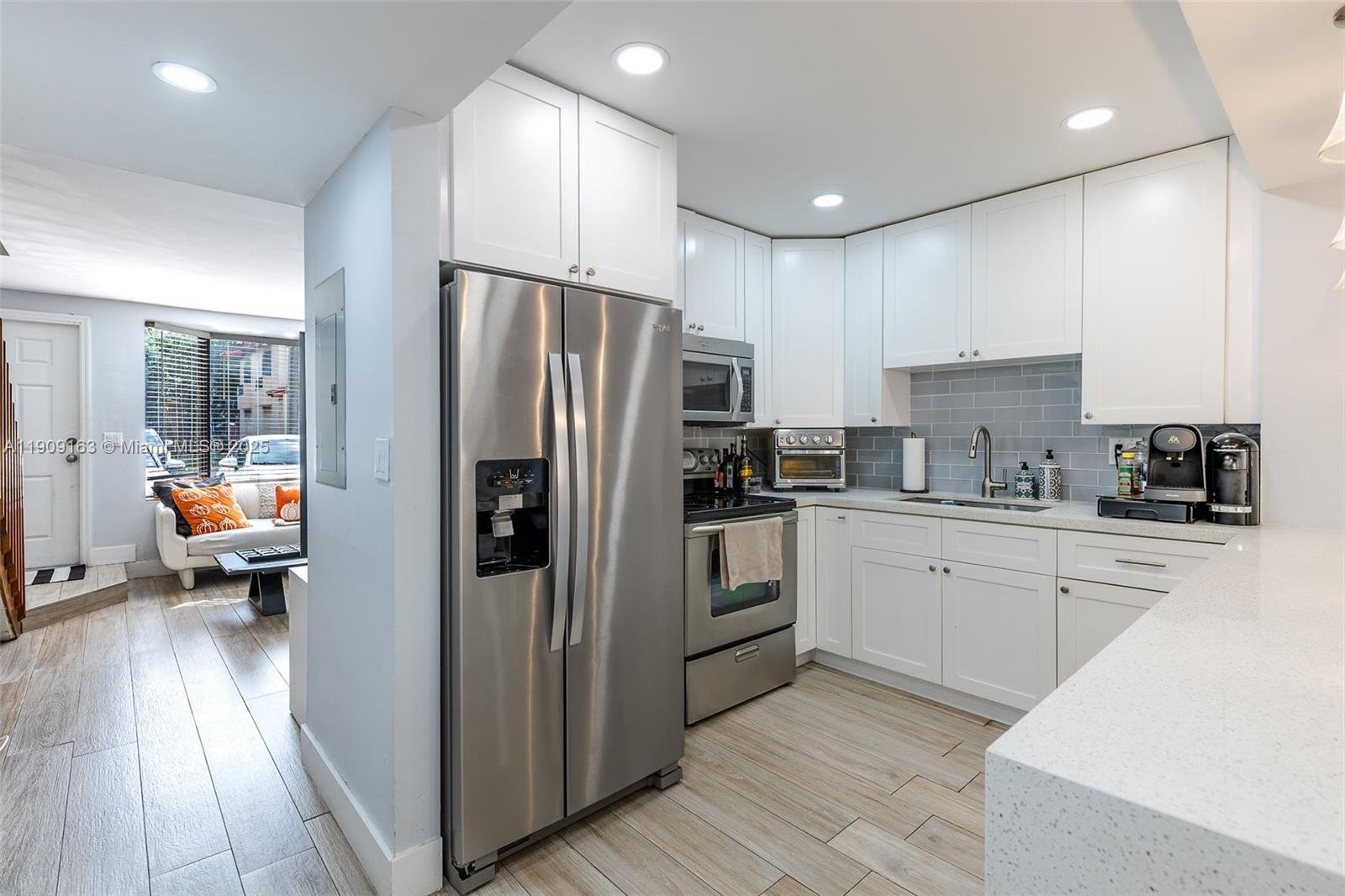 10037 Southwest 77th Court Miami, FL 33156 - Photo 13 of 70 a kitchen with stainless steel appliances refrigerator oven table and chairs