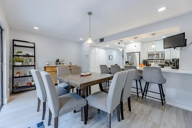 a kitchen with a sink a window and cabinets