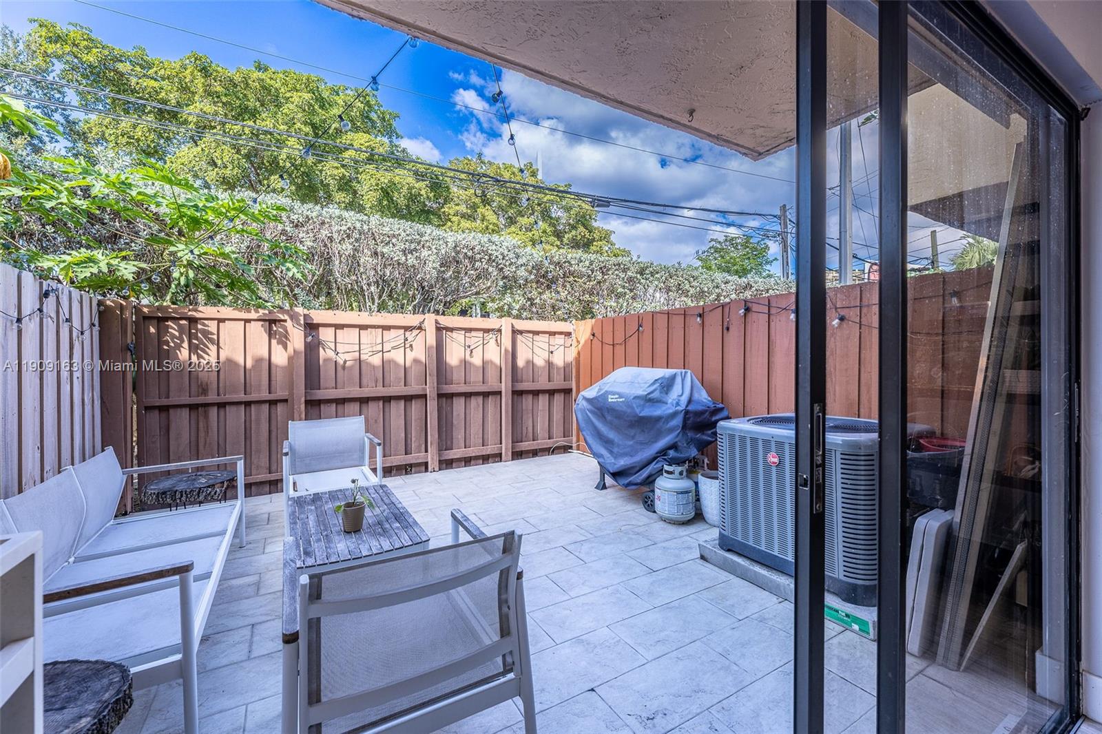 10037 Southwest 77th Court Miami, FL 33156 - Photo 18 of 70 a view of a chair and tables in the patio