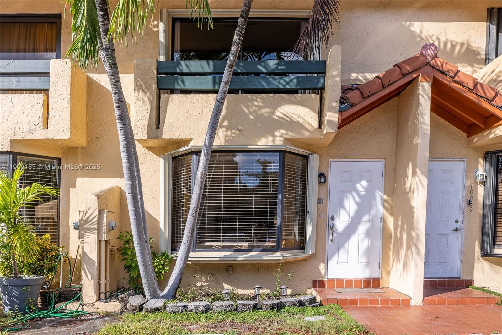 10037 Southwest 77th Court Miami, FL 33156 - Photo 2 of 70 a front view of a house with a yard