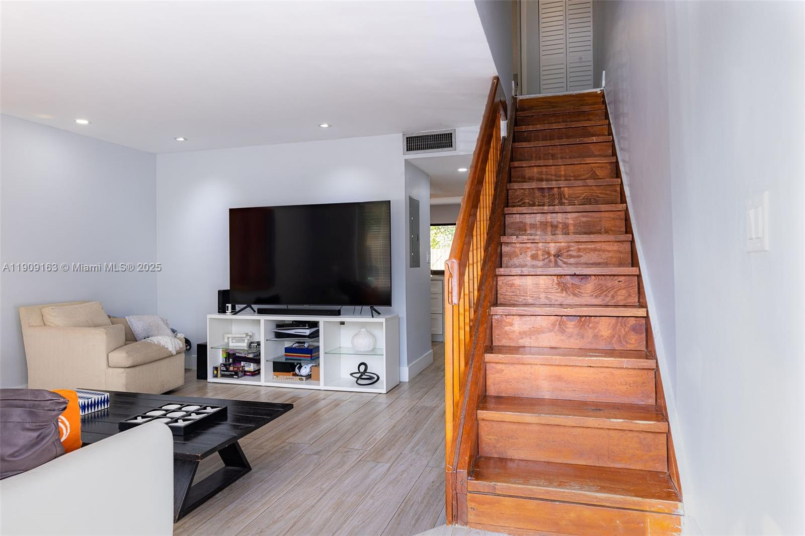 10037 Southwest 77th Court Miami, FL 33156 - Photo 22 of 70 a living room with furniture and a flat screen tv