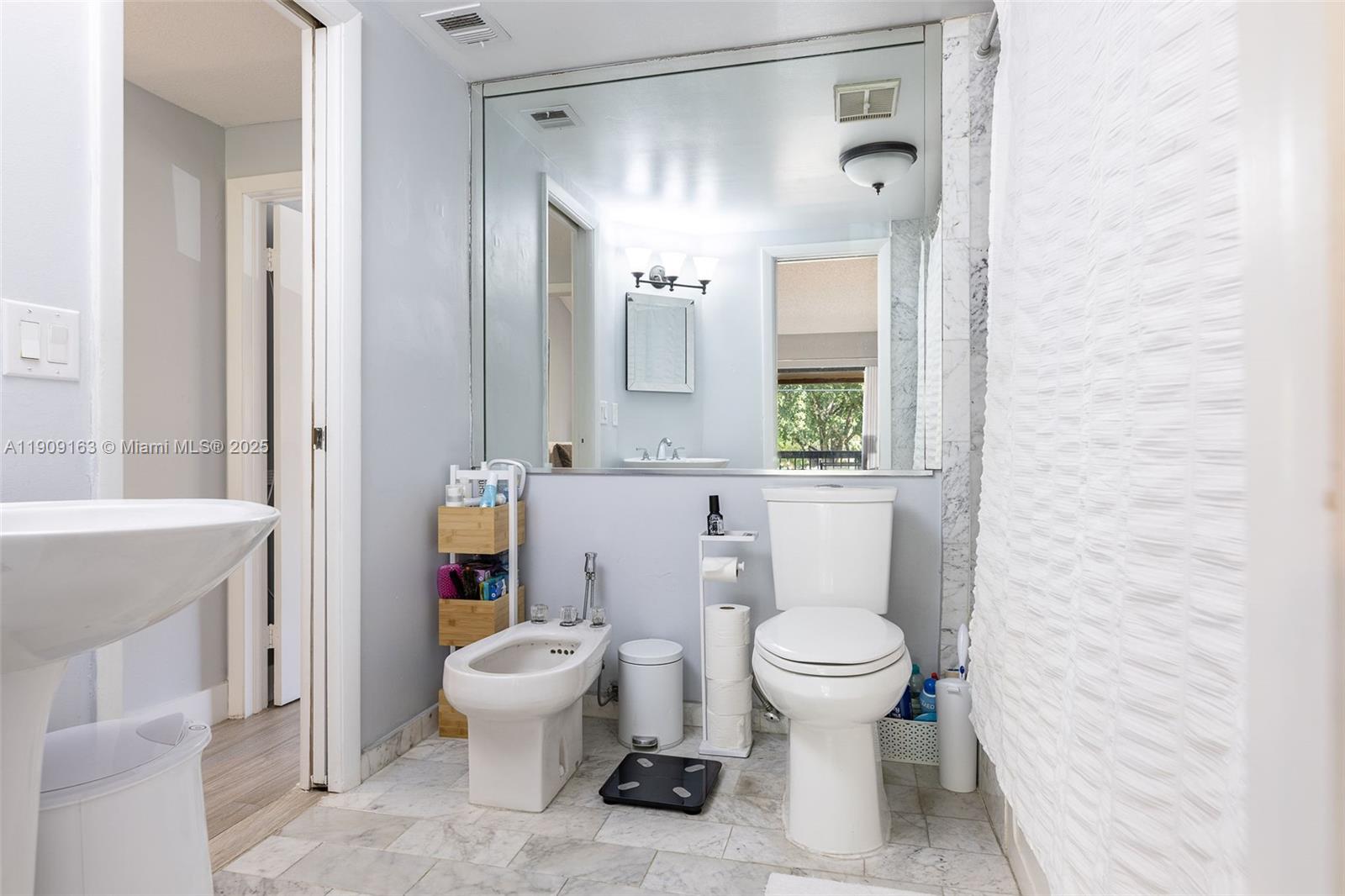 10037 Southwest 77th Court Miami, FL 33156 - Photo 26 of 70 a bathroom with a toilet sink and mirror