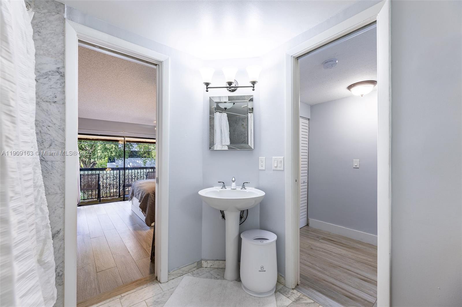 10037 Southwest 77th Court Miami, FL 33156 - Photo 32 of 70 a bathroom with a sink a mirror and shower