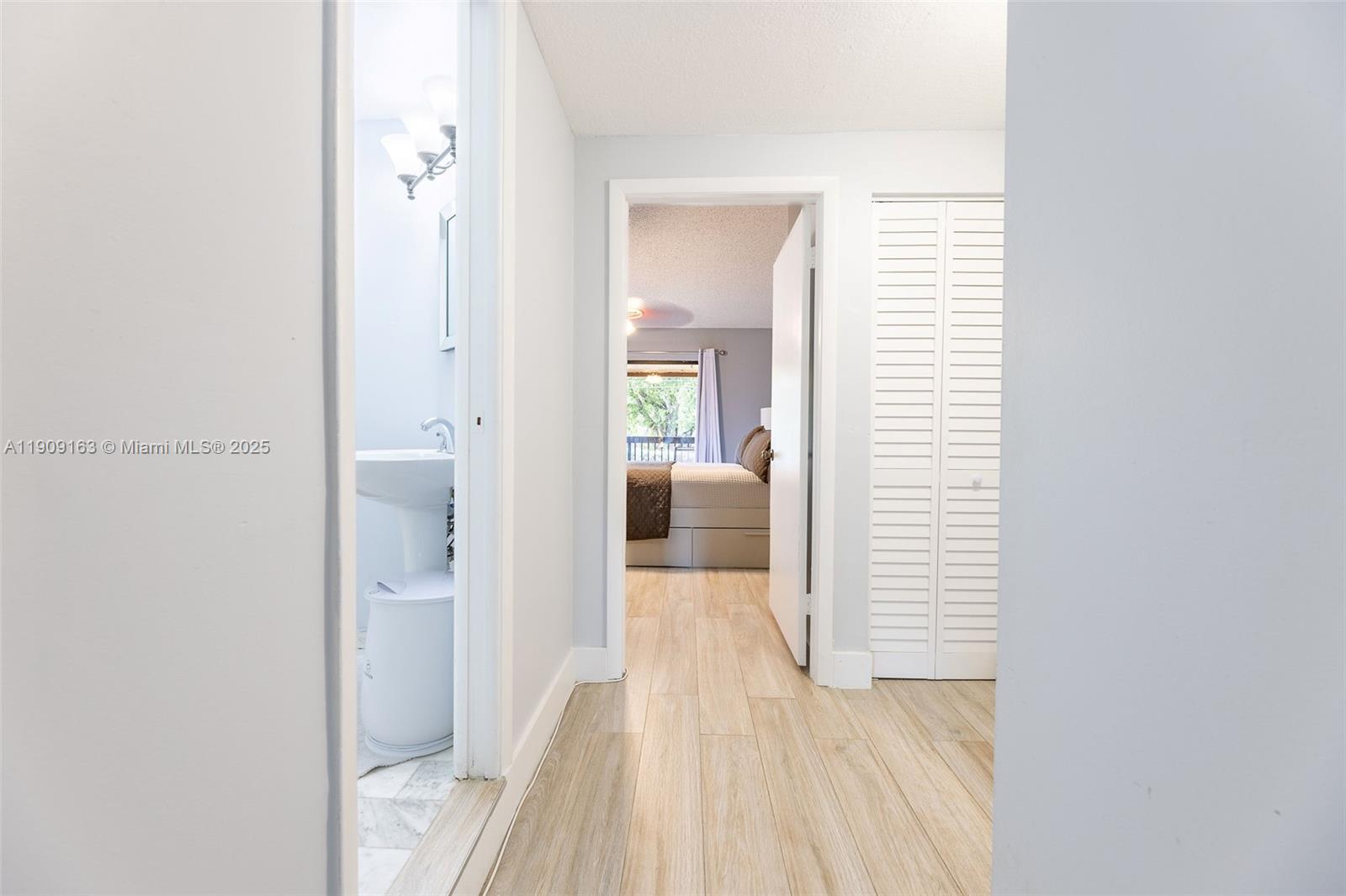 10037 Southwest 77th Court Miami, FL 33156 - Photo 33 of 70 a view of a bedroom from a hallway