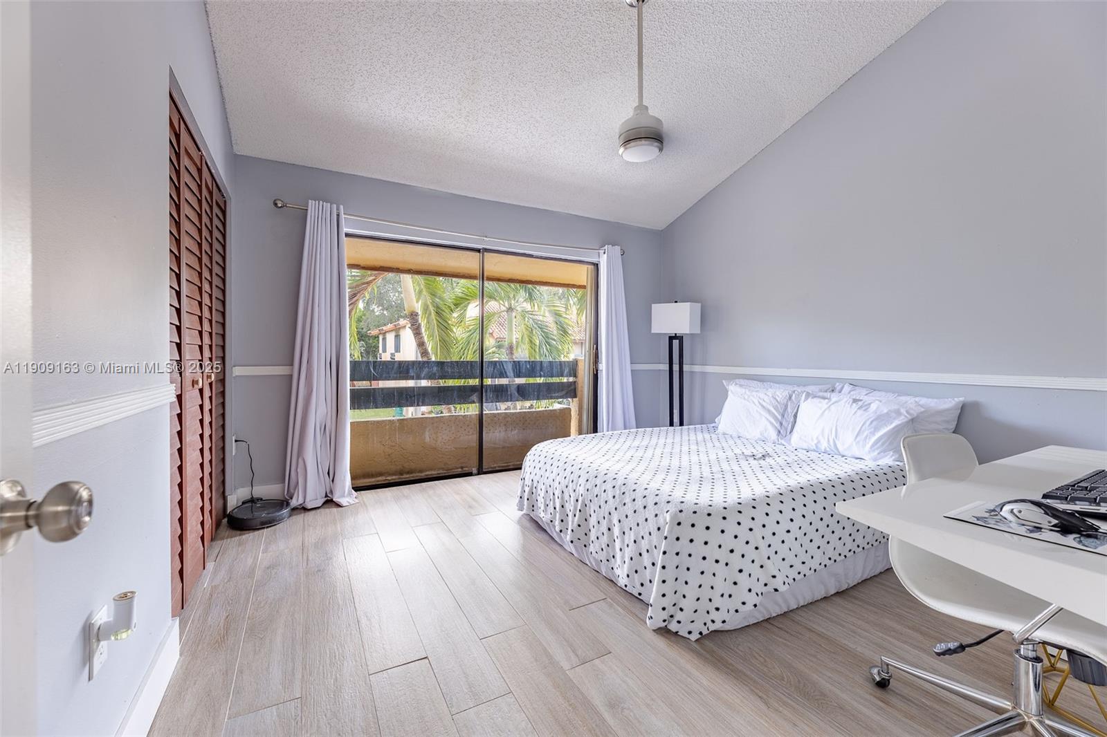 10037 Southwest 77th Court Miami, FL 33156 - Photo 34 of 70 a bedroom with a bed and a large window