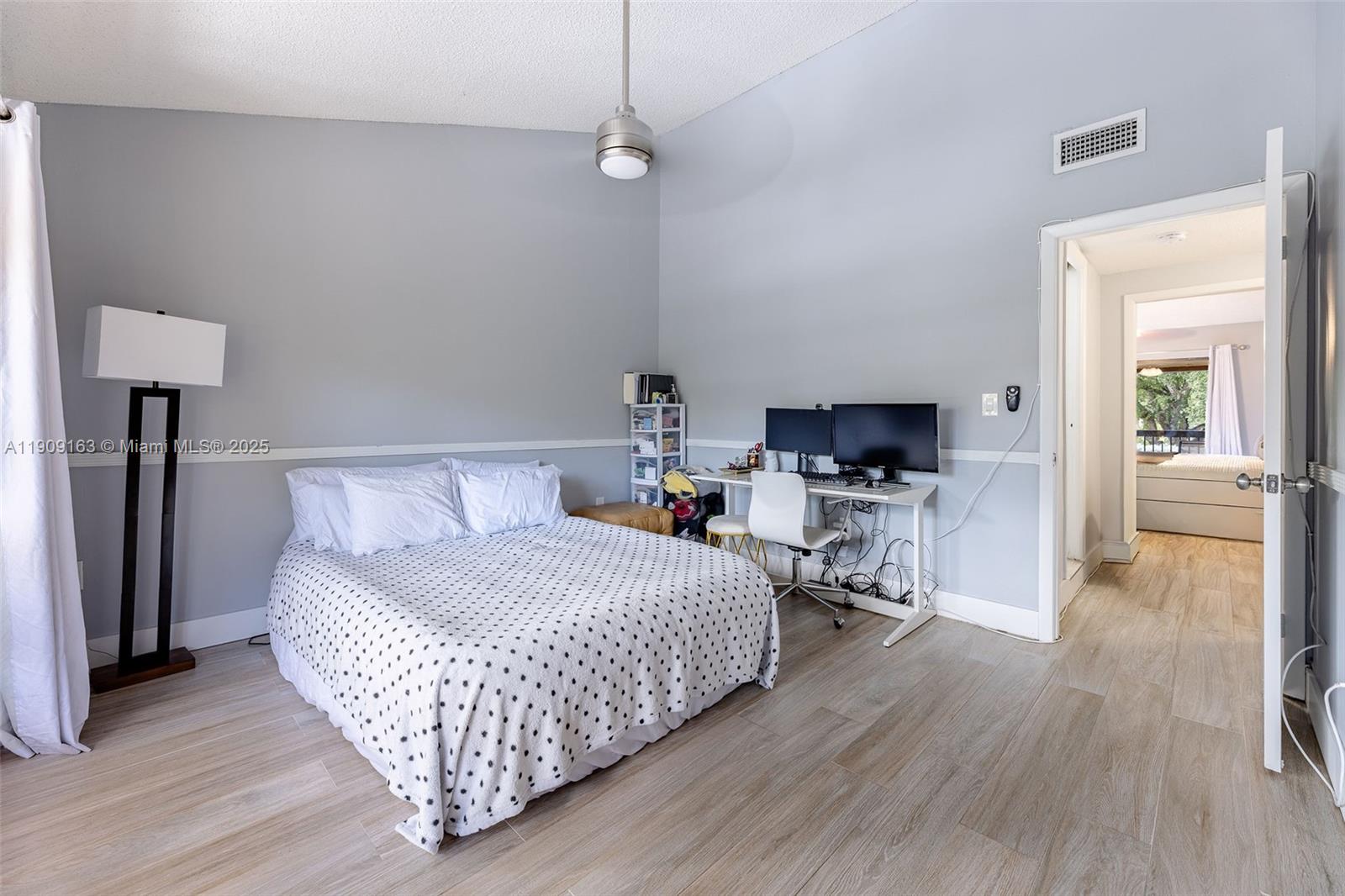 10037 Southwest 77th Court Miami, FL 33156 - Photo 35 of 70 a bedroom with a bed and a table in it