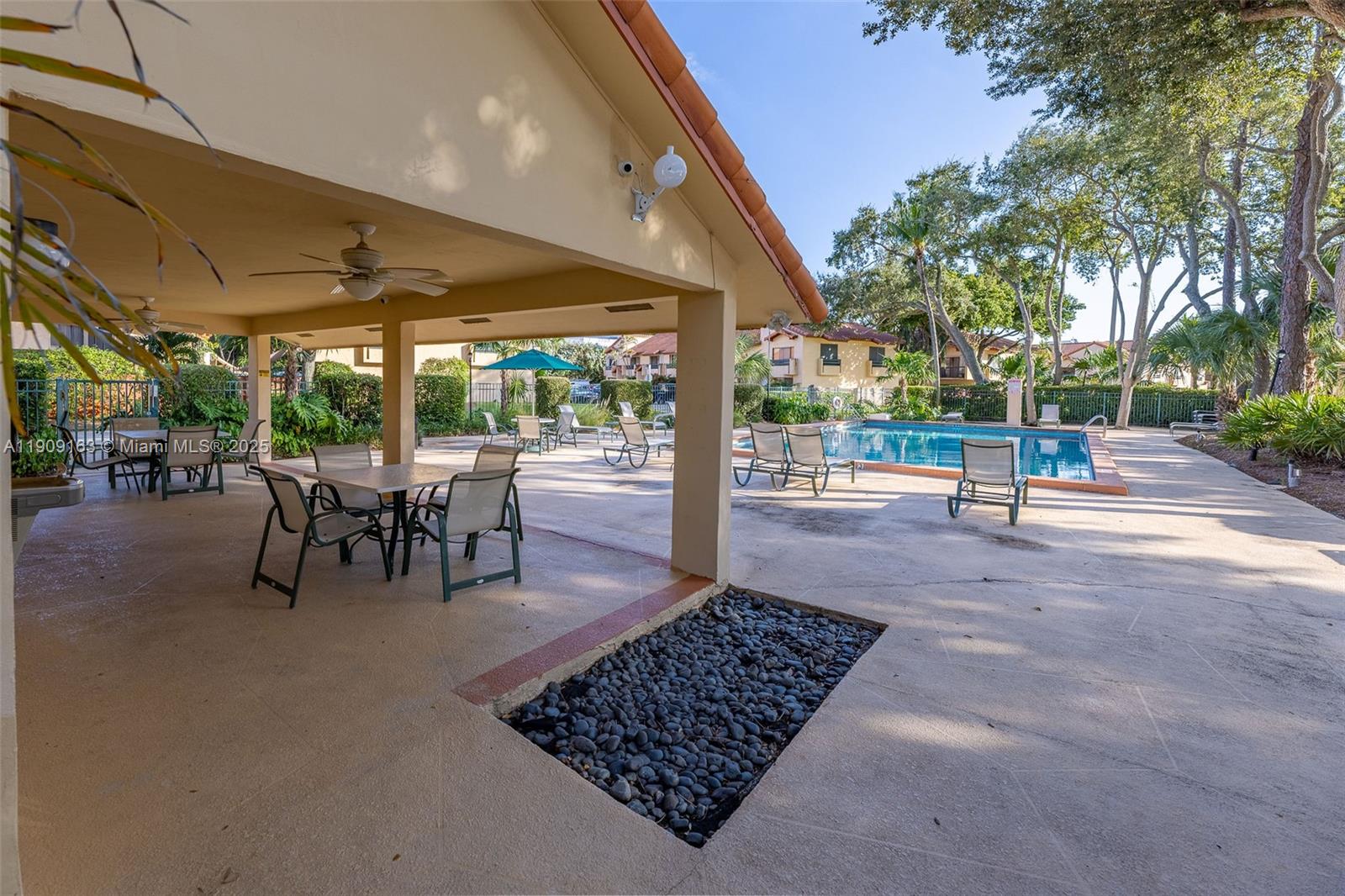 10037 Southwest 77th Court Miami, FL 33156 - Photo 59 of 70 a view of a porch with chairs and backyard