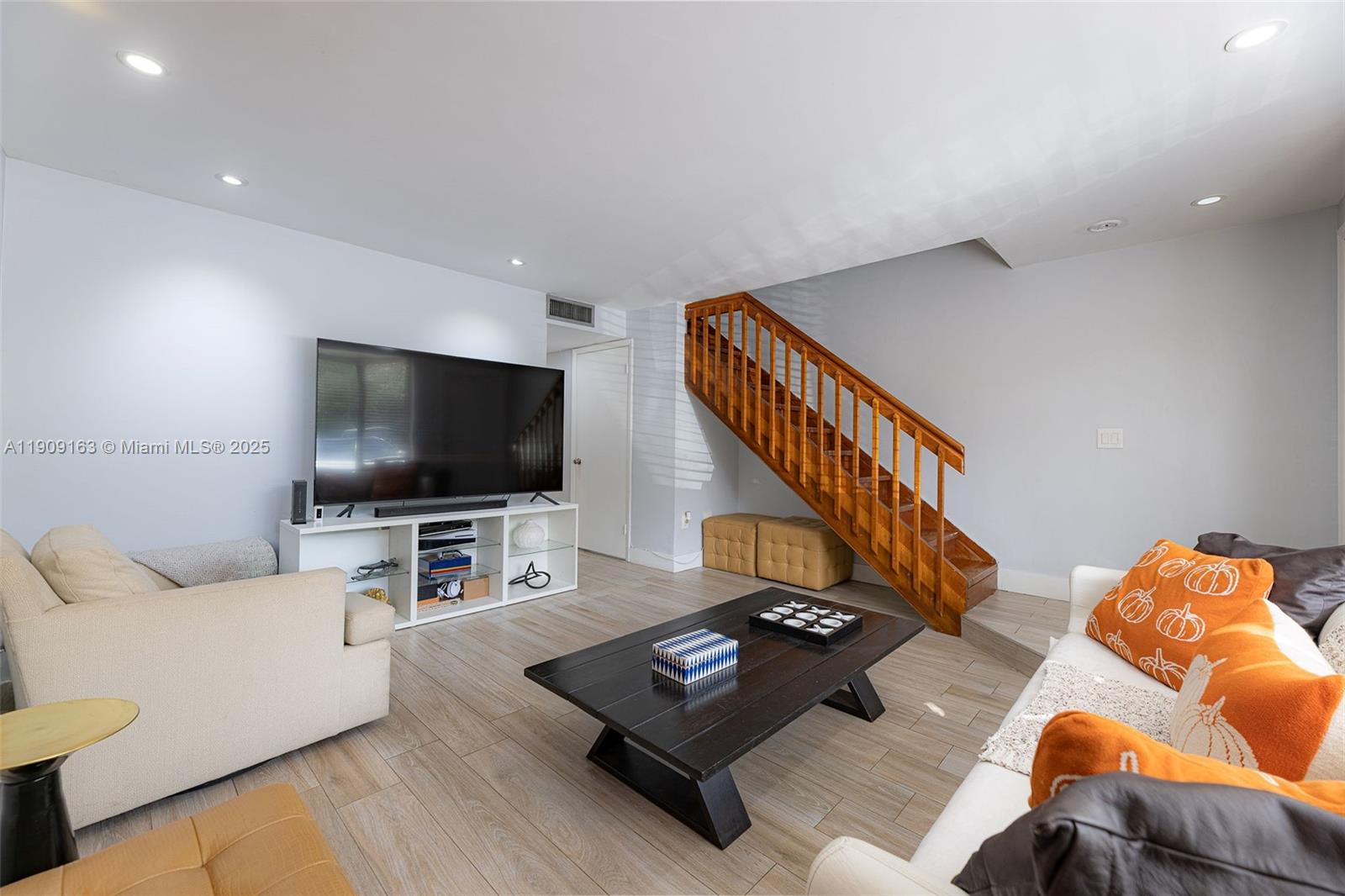 10037 Southwest 77th Court Miami, FL 33156 - Photo 6 of 70 a living room with furniture and a flat screen tv