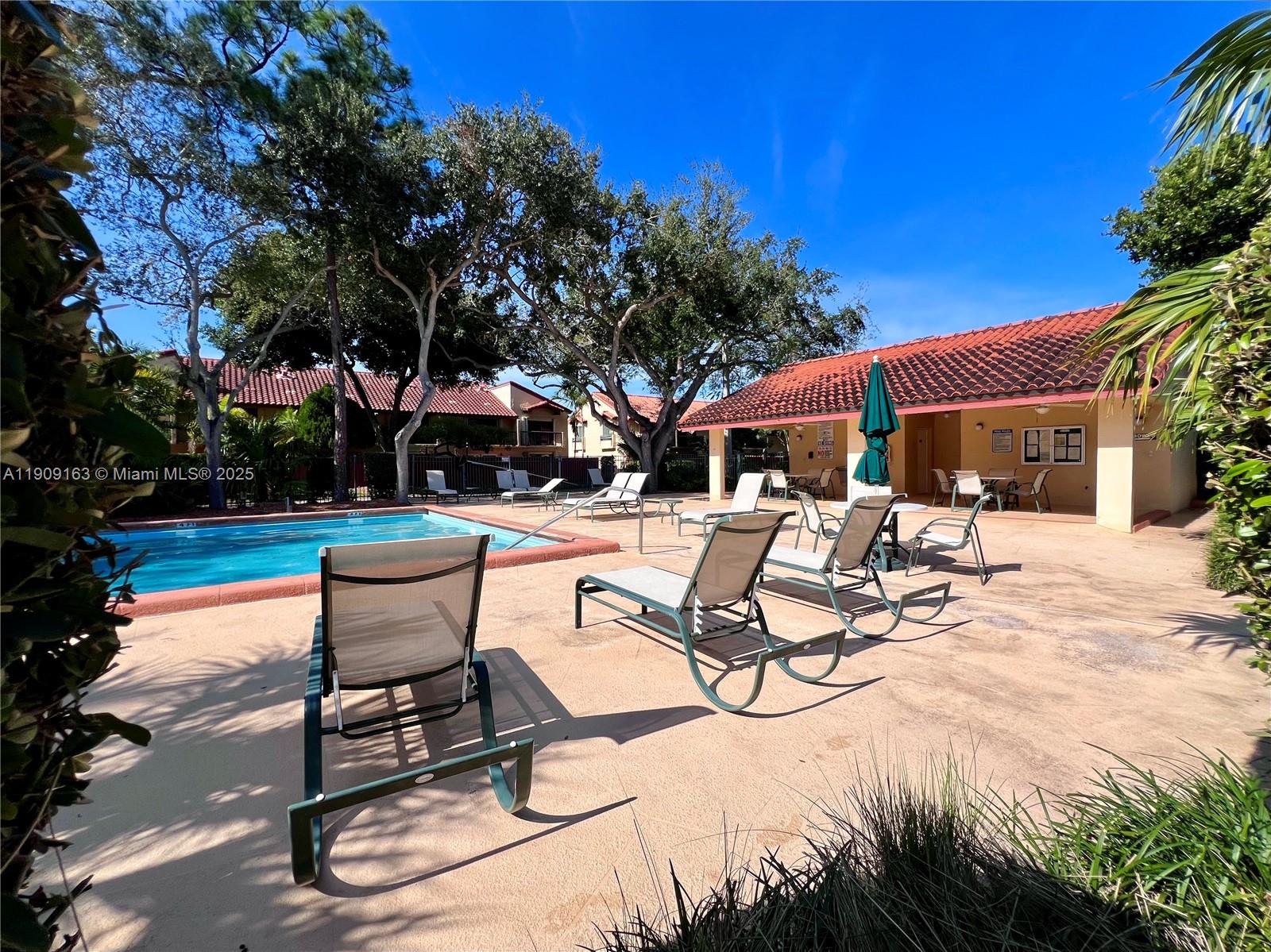 10037 Southwest 77th Court Miami, FL 33156 - Photo 63 of 70 a view of patio with table and chairs and potted plants with large tree