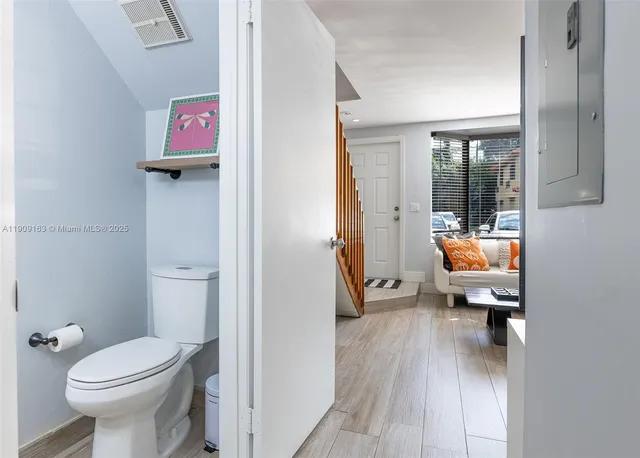 a bathroom with a sink a toilet a mirror and shower