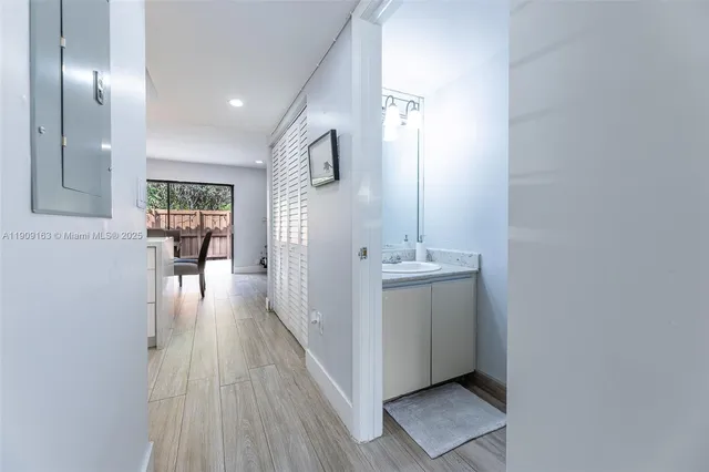 a kitchen with a table chairs and wooden floor