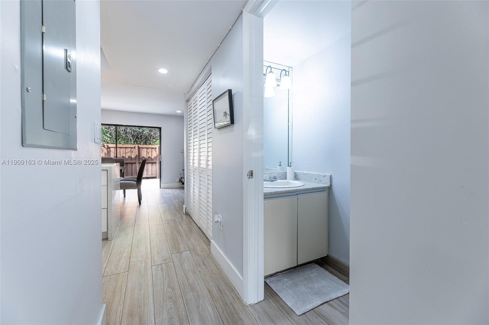 10037 Southwest 77th Court Miami, FL 33156 - Photo 10 of 70 a view of a hallway with wooden floor and staircase