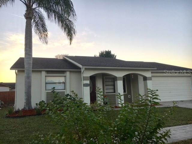 11524 Bear Paw Lane Port Richey, FL 34668 - Photo 1 of 1 a front view of a house with a garden