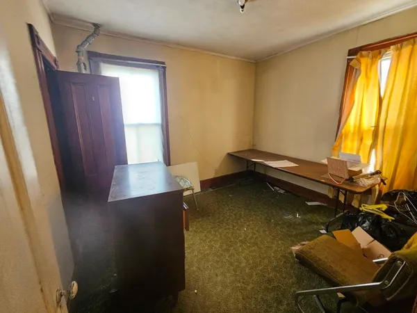 a room with chairs and window