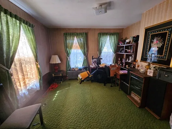 a living room with furniture a window and a flat screen tv