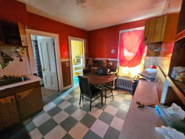 a living room with furniture a rug and a piano