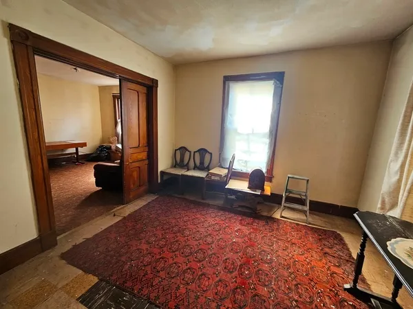 a living room with furniture rug and window