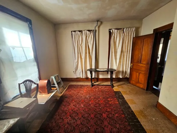 a bed sitting in a bedroom next to a window