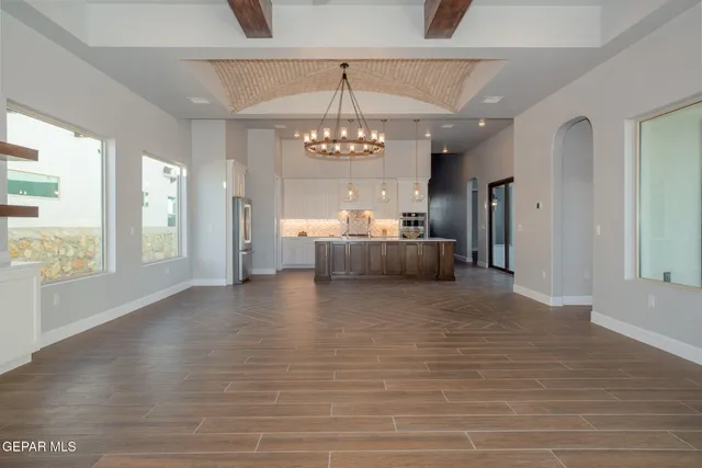a view of empty room with wooden floor and window