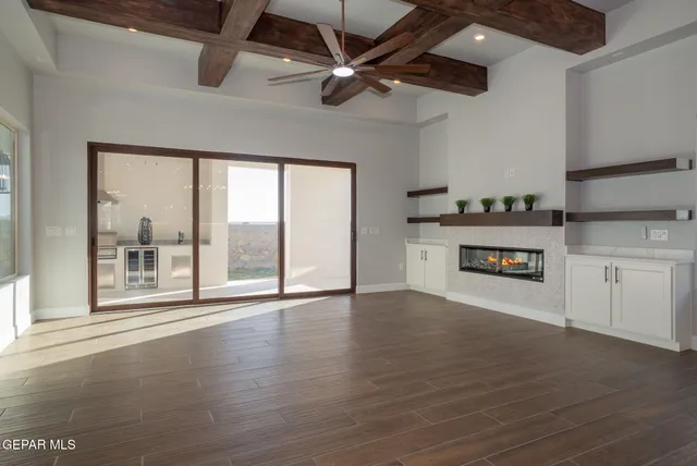 a dining room with furniture a chandelier and wooden floor