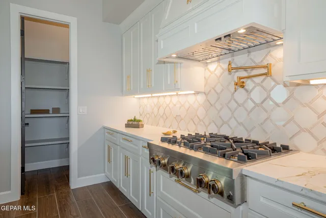 a large kitchen with a large window a sink and stainless steel appliances